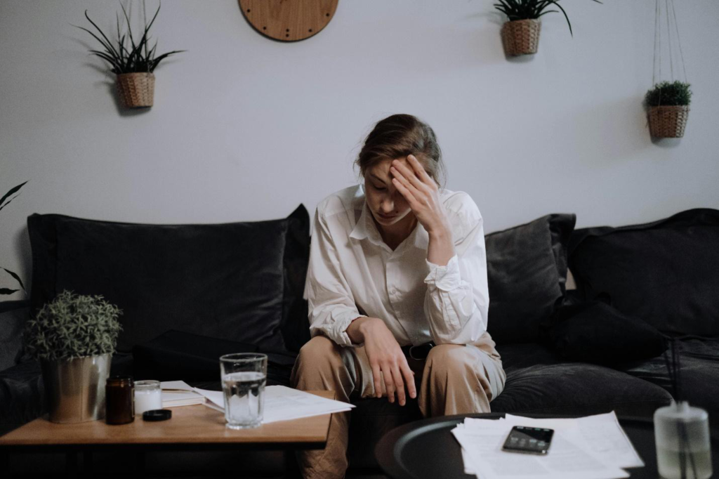 A picture of a tired person sitting on a sofa