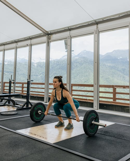 A woman lifting weights at a gym