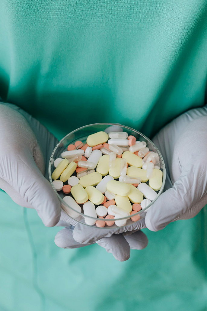 A picture of a doctor holding a container of pills