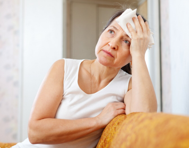 A person experiencing hot flashes